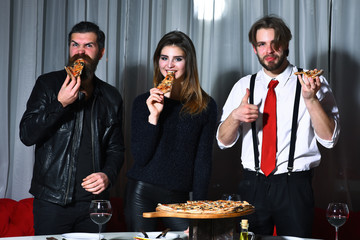 Happy friends eating tasty pizza slices