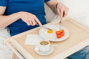 Obraz na płótnie Canvas Man having Breakfast in bed