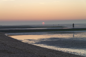 Human silhouette against the background of the setting sun