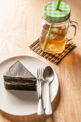 ice tea and chocolate cake on wooden table