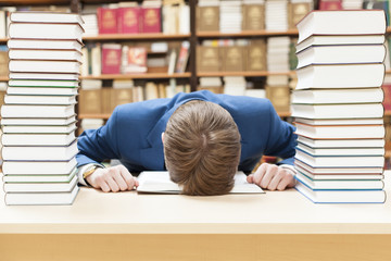 The student is asleep in the library