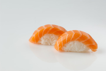 close up of sushi with rice on white background with reflection