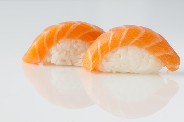 close up of sushi with rice on white background with reflection