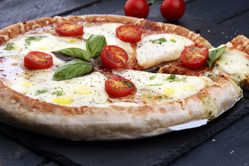 Hot true PEPPERONI ITALIAN PIZZA with salami and cheese. TOP VIEW Tasty traditional pepperoni pizza on board on wooden table with decoration