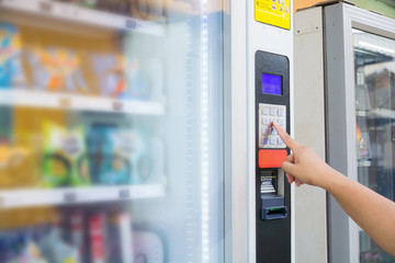 Female Hand Push Button to make Transaction Code or Number on Modern Automatic Vending Machine