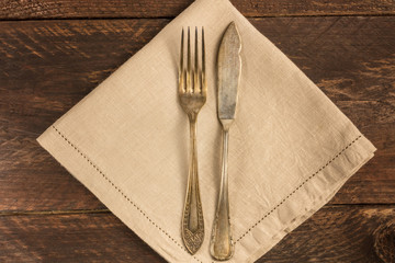 Vintage fork and knife on wooden background