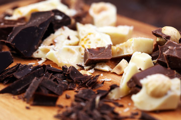 Chocolate bars on a wooden background with chocolate tower