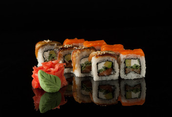 set of sushi cubes with wasabi on a black background with reflection