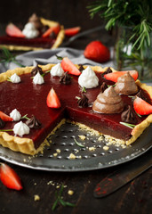 Vegan tart with chocolate and strawberry jelly