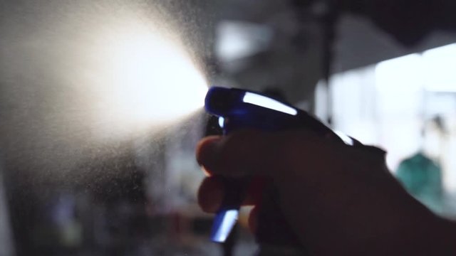 Using spraying bottle and cleaning on black background shooting with high speed camera, phantom flex.