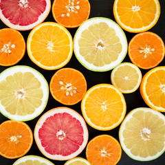 Fototapeta na wymiar Lemon, orange, mandarin, grapefruit and sweetie isolated on black background. Flat lay, top view. Fruit background