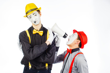 Two clown, MIME, flashy Megaphone. The expression of emotions. On a white background.