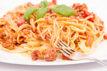 Spaghetti bolognese being eaten with a fork