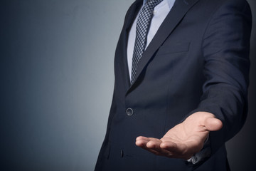 An empty workpiece. Gesture of alms begging. Businessman stretches out his hand.