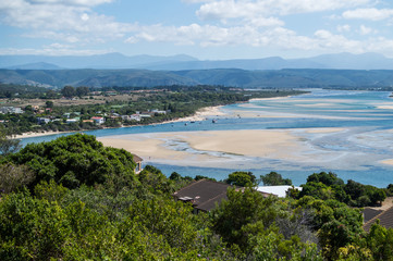 Naklejka na ściany i meble Beach and Coastline with Inlet and Houses Seen from a Lookout at Plettenberg Bay in South Africa