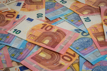 Different euro notes spread on a table