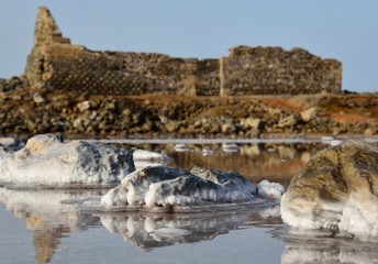 Stones with crystallized salt in old salines and ruins background, Gran canaria island 