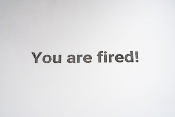 Unemployment. Inscription You are fired on the white paper