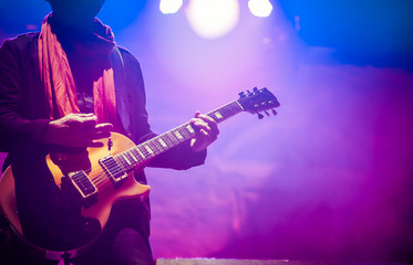 Obraz na płótnie Canvas guitarist on stage - summer music festival