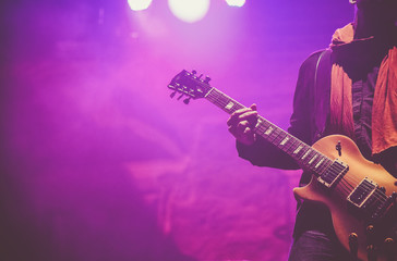 Obraz na płótnie Canvas guitarist on stage - summer music festival