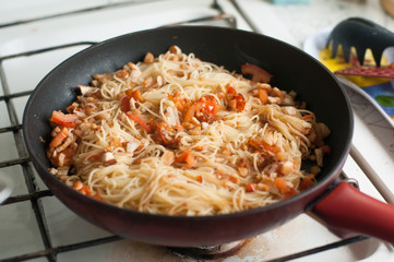 Chicken and paprika on frying pan