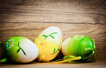 easter card with eggs and pussy willow on rustic wooden background