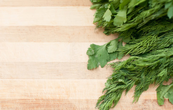 Dill and parsley on the cutting board