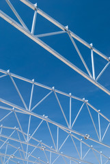 Obraz premium Galvanized steel roof truss construction frames with deep blue sky in the background