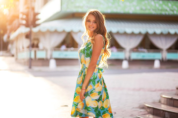 Happy beautiful young woman smiling in the street at sunny summer day.