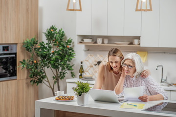 Joyful family using laptop at home