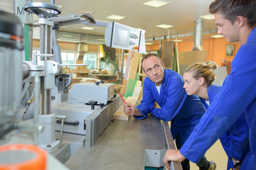 apprentices and their teacher in the workshop