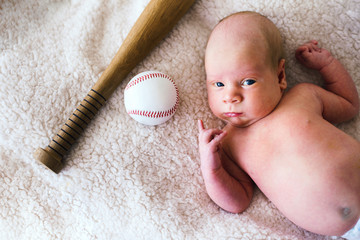 Newborn baby boy with baseball bat and ball. Future champion © VlaDee