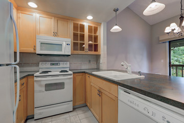 Tidy compact kitchen with maple cabinets