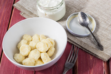 Traditional russian, ukrainian cottage cheese lazy dumplings served with sour cream and cherry