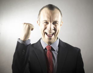 Businessman in suit celebrating