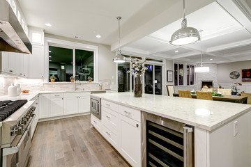 Gourmet kitchen features white cabinetry