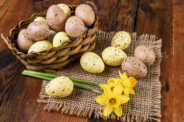 Easter eggs in basket. Retro decoration  pastel colors on old wooden table