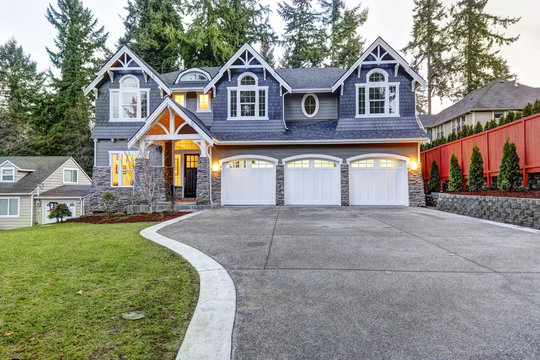 Luxurious Blue Home With Three Attached Garage Spaces