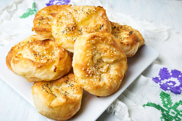 Homemade cheese pie rolls covered with sesame
