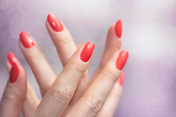 Close up on beautiful female hands with Red manicure.