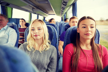 happy young women riding in travel bus