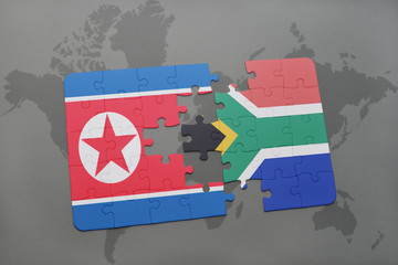puzzle with the national flag of north korea and south africa on a world map
