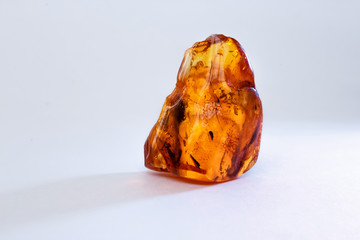 a piece of raw amber on a white table