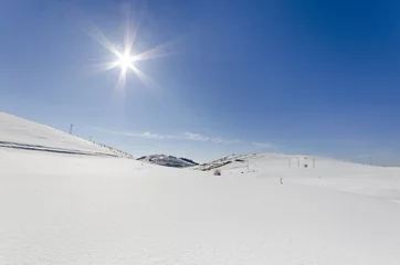 Fotobehang Mountains with snow in winter under sun © zefart