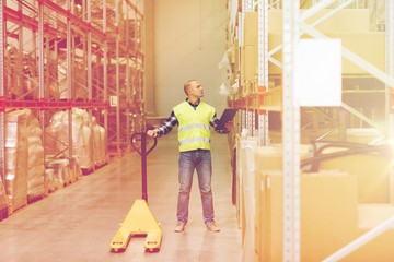 man with loader and clipboard at warehouse