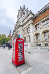 Old phone box in front of Victoria and Albert Museum facade at London, England