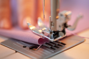 Fototapeta na wymiar sewing machine presser foot stitching fabric