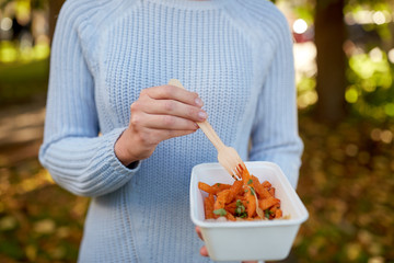 close up of hand holding plate with sweet potato
