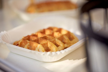 close up of waffle on paper plate