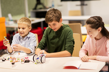 happy children building robots at robotics school